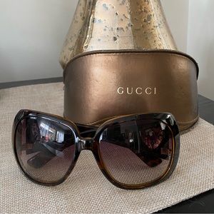 Gucci tortoise rectangle Havana sunglasses with gold heart accent on side.